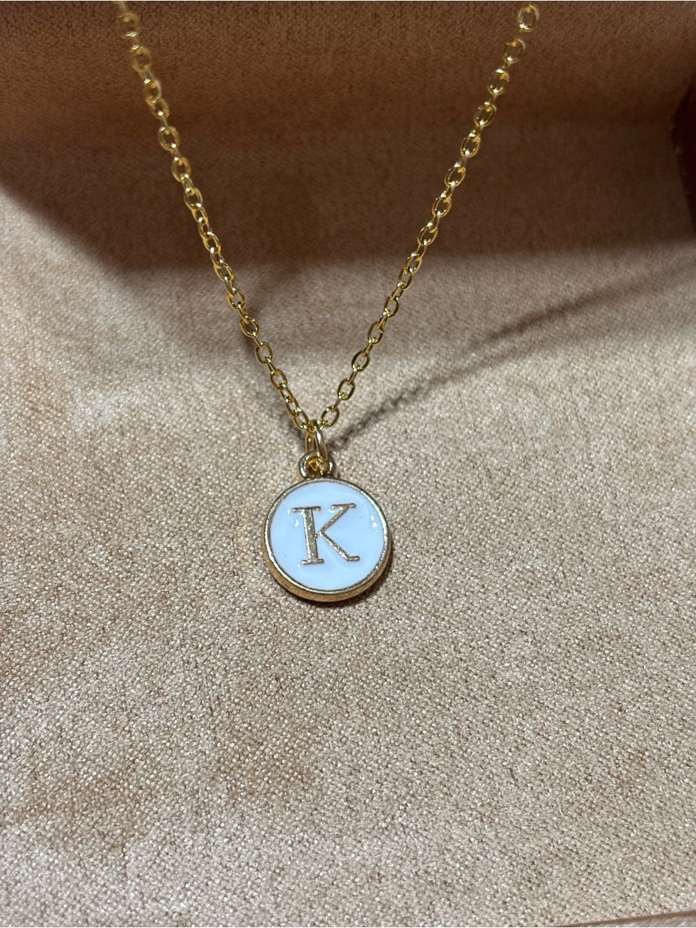 Gold tone initial K pendant necklace